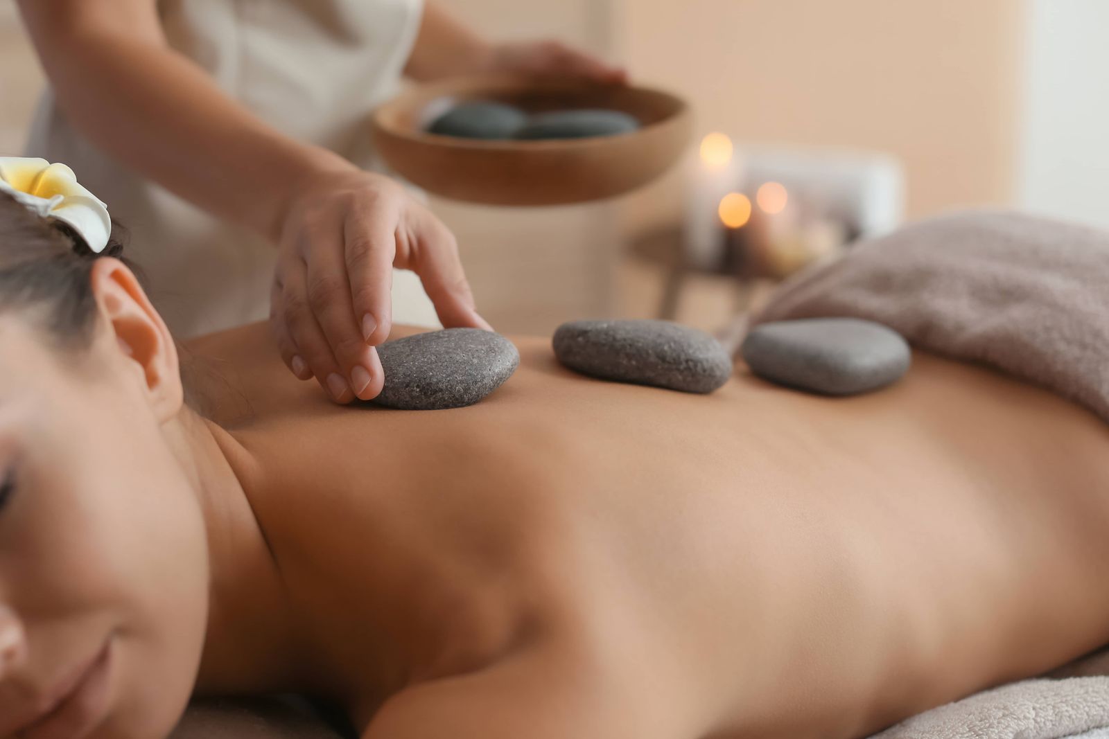 Hot Stone Massage mit erwärmten Basaltsteinen zur Entspannung und Durchblutungsförderung – bei QUAN in Lambsheim